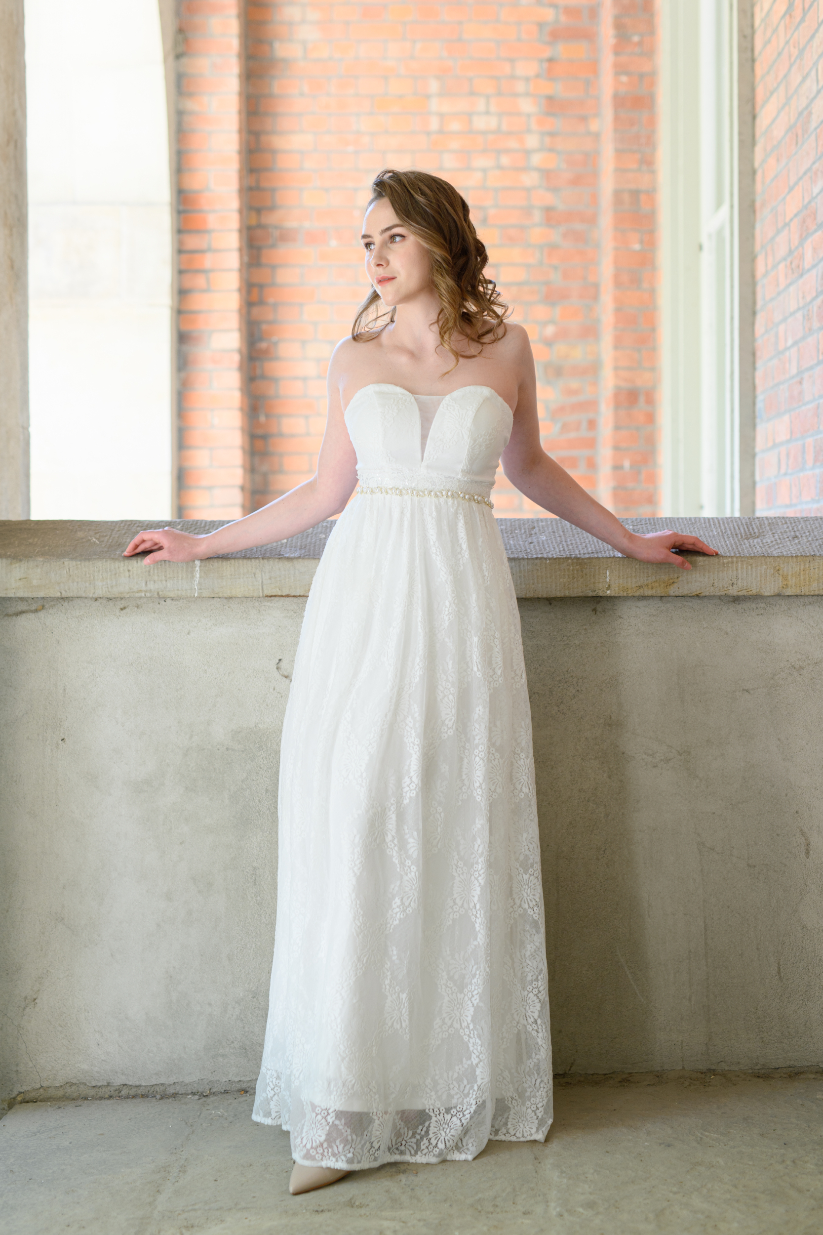 Introducing Gloria, a captivating strapless sheath wedding dress that embodies timeless beauty. The sweetheart and illusion neckline accentuate your natural grace and beauty. Detailed beads and pearls on the waistline add a touch of glamour and sophistication to this simple yet elegant gown.