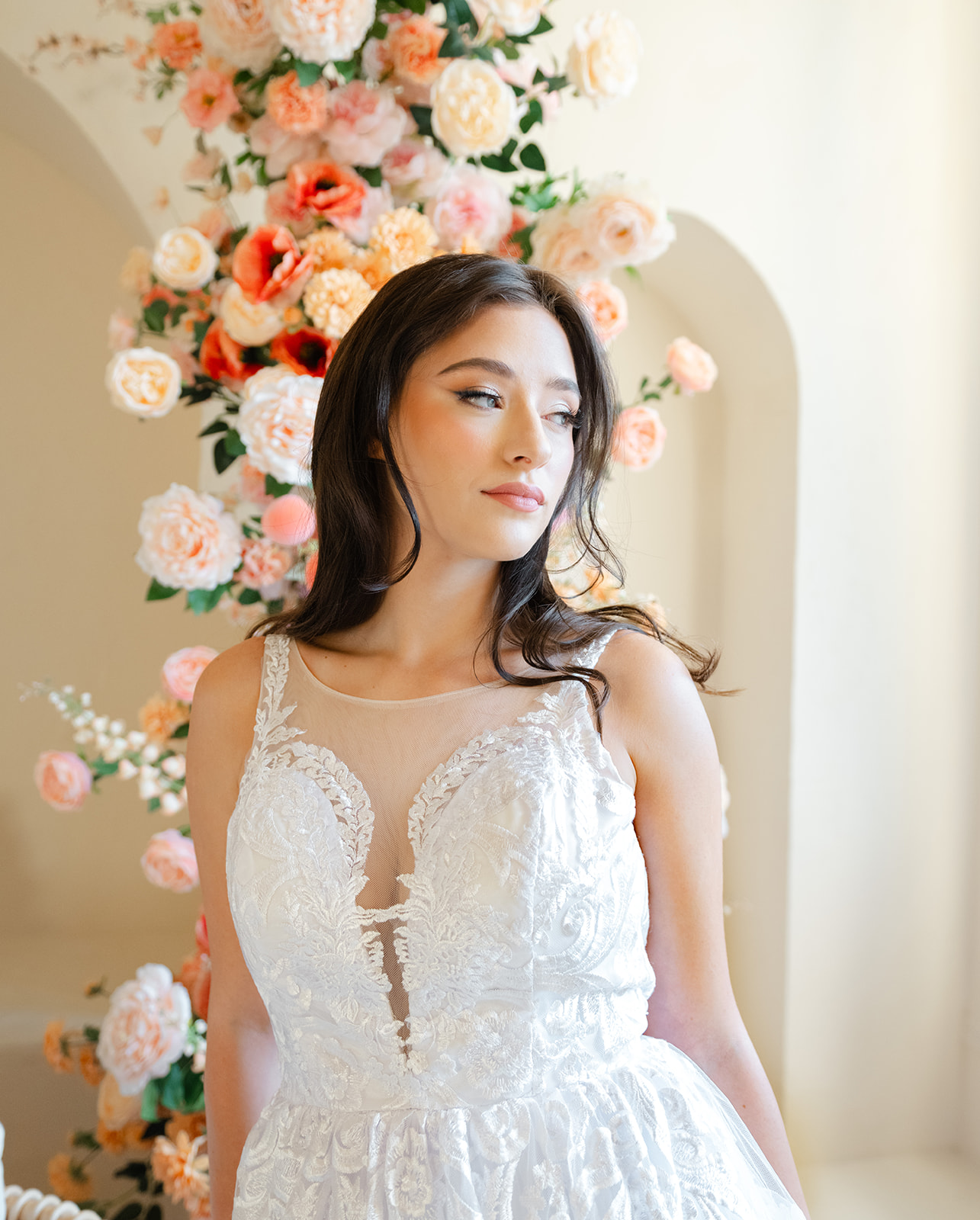 Klara: A captivating wedding gown with an illusion front and exquisite lace embroidery, available for rental in Toronto. Experience timeless elegance for your special day