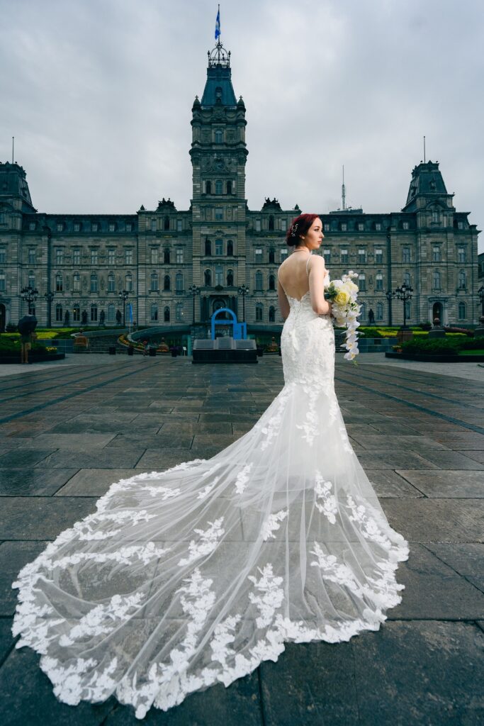 Discover Beverly, a stunning mermaid wedding dress with a V-neckline, illusion front, embroidered bodice, and a lace and embroidery church-length train. Ideal for brides seeking a fitted, detailed gown. Rent it at Love Deities, Toronto.